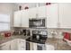 Modern kitchen with granite countertops and stainless steel appliances at 3231 Cupid Pl Pl, Kissimmee, FL 34747