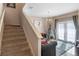 Well-lit carpeted staircase leading to an open living area at 3231 Cupid Pl Pl, Kissimmee, FL 34747