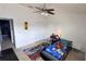 This bedroom features a fun race car bed, a ceiling fan, and plenty of room to play at 525 Waterside Pointe Dr, Groveland, FL 34736