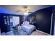 This bedroom features unique wall art, a ceiling fan, and bright LED lighting, perfect for a teen or young adult at 525 Waterside Pointe Dr, Groveland, FL 34736