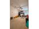 Spacious bonus room with a ceiling fan, neutral carpeting, and ample space for play or relaxation at 525 Waterside Pointe Dr, Groveland, FL 34736