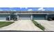 Attached garages with concrete driveway and green space at 525 Waterside Pointe Dr, Groveland, FL 34736