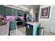 Stylish kitchen boasting green cabinetry, stainless steel appliances, and granite countertops at 525 Waterside Pointe Dr, Groveland, FL 34736