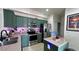 Bright kitchen boasts stainless appliances, green cabinets, and an island for added workspace at 525 Waterside Pointe Dr, Groveland, FL 34736