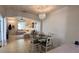 Open floor plan features a dining area with chandelier flowing into a comfortable living room with ample natural light at 525 Waterside Pointe Dr, Groveland, FL 34736