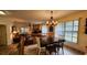 Charming dining area with a rustic wooden table and chandelier at 469 Blue Heron Cir # 469, River Ranch, FL 33867