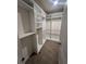 Spacious walk-in closet with built-in shelving and hanging rods at 913 Shady Tree Lane Ln, Davenport, FL 33897