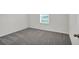 Simple bedroom with grey carpet and window at 15605 Sw 49Th Ave Rd, Ocala, FL 34473