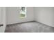 Simple bedroom with grey carpet and window at 15605 Sw 49Th Ave Rd, Ocala, FL 34473