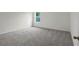 Simple bedroom with grey carpet and window at 15605 Sw 49Th Ave Rd, Ocala, FL 34473