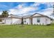 White house with gray roof, two car garage, and landscaped yard at 15605 Sw 49Th Ave Rd, Ocala, FL 34473
