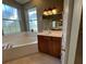 Large bathroom with corner soaking tub and vanity at 2300 Se 73Rd Loop, Ocala, FL 34480