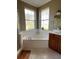 Relax in this spa-like bathroom, featuring a large corner tub and double sinks at 2300 Se 73Rd Loop, Ocala, FL 34480