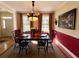 Formal dining room with large windows, chandelier, and wood table at 2300 Se 73Rd Loop, Ocala, FL 34480