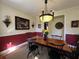 Elegant dining room featuring a wood table, chandelier, and rich wall colors at 2300 Se 73Rd Loop, Ocala, FL 34480