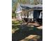 Peaceful front yard with a wooden swing at 2300 Se 73Rd Loop, Ocala, FL 34480