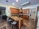 L-shaped kitchen with granite counters and island at 2300 Se 73Rd Loop, Ocala, FL 34480