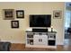 Living room showcasing a large TV, media console, and framed artwork at 2300 Se 73Rd Loop, Ocala, FL 34480