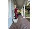 Brick porch with columns, plants, and rocking chairs at 2300 Se 73Rd Loop, Ocala, FL 34480