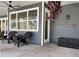 Inviting covered porch with wicker chairs and ceiling fan at 2300 Se 73Rd Loop, Ocala, FL 34480