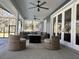 Relaxing screened porch with wicker furniture and fire pit at 2300 Se 73Rd Loop, Ocala, FL 34480