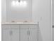 Double vanity bathroom with neutral cabinets and quartz countertop at 5830 Sw 121 St, Ocala, FL 34481