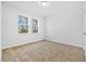 Well-lit bedroom with neutral carpeting and two windows at 5830 Sw 121 St, Ocala, FL 34481
