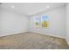 Spacious bedroom with neutral carpeting and two large windows at 5830 Sw 121 St, Ocala, FL 34481