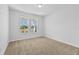Spacious bedroom with neutral carpet and two windows at 5830 Sw 121 St, Ocala, FL 34481