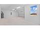 Spacious garage with overhead door and light-colored walls at 5830 Sw 121 St, Ocala, FL 34481