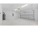 Spacious garage with overhead door and light-colored walls at 5830 Sw 121 St, Ocala, FL 34481