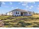 Single story house with light colored exterior and grassy backyard at 5830 Sw 121 St, Ocala, FL 34481