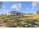 Single story house with light colored exterior and grassy backyard at 5830 Sw 121 St, Ocala, FL 34481