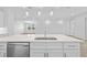 Kitchen island with sink, dishwasher and white cabinets at 5830 Sw 121 St, Ocala, FL 34481