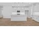 Bright kitchen with island, stainless steel appliances, and white cabinets at 5830 Sw 121 St, Ocala, FL 34481