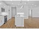 Modern kitchen with white cabinets, quartz counters, and island at 5830 Sw 121 St, Ocala, FL 34481