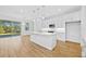 Bright kitchen with island, stainless steel appliances, and white cabinets at 5830 Sw 121 St, Ocala, FL 34481