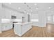 Modern kitchen boasts white cabinets and a large island at 5830 Sw 121 St, Ocala, FL 34481