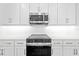Stainless steel range and microwave in a modern kitchen at 5830 Sw 121 St, Ocala, FL 34481
