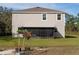 Home exterior showcasing a large backyard and screened patio at 3681 Magnolia Dr, Indian Lake Estates, FL 33855