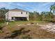 Home exterior showcasing a large backyard and screened patio at 3681 Magnolia Dr, Indian Lake Estates, FL 33855