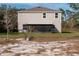 Home exterior showcasing a large backyard and screened patio at 3681 Magnolia Dr, Indian Lake Estates, FL 33855