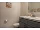 Small bathroom with gray vanity, toilet, and white walls at 3681 Magnolia Dr, Indian Lake Estates, FL 33855
