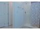 Clean bathroom with shower and double doors at 3681 Magnolia Dr, Indian Lake Estates, FL 33855