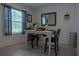 Charming dining area with white table, gray chairs, and a window view at 3681 Magnolia Dr, Indian Lake Estates, FL 33855