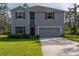 Two-story house with gray siding, red shutters, and a two-car garage at 3681 Magnolia Dr, Indian Lake Estates, FL 33855