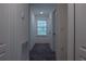 Hallway with window and carpet flooring at 3681 Magnolia Dr, Indian Lake Estates, FL 33855