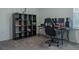 Home office features a large desk, comfortable chair, and shelving unit for storage at 3681 Magnolia Dr, Indian Lake Estates, FL 33855