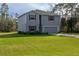 Two-story house with gray siding and red shutters at 3681 Magnolia Dr, Indian Lake Estates, FL 33855