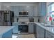 Modern kitchen with stainless steel appliances and gray cabinets at 3681 Magnolia Dr, Indian Lake Estates, FL 33855